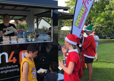 Children being served by the Ten4 Community bbq trailer